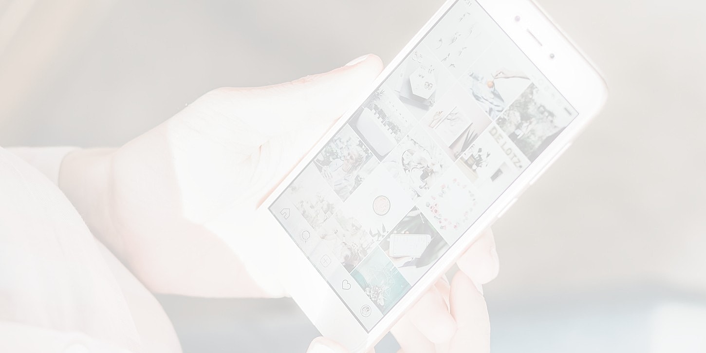 Person holding smartphone displaying social media feed