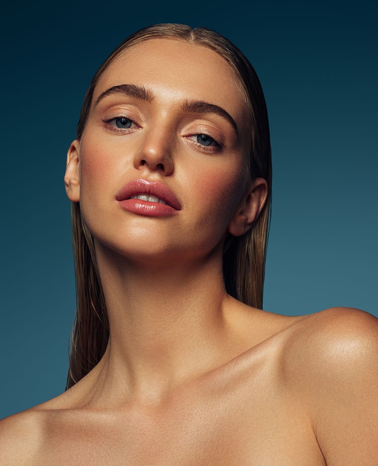 Model with smooth skin and wet hair.