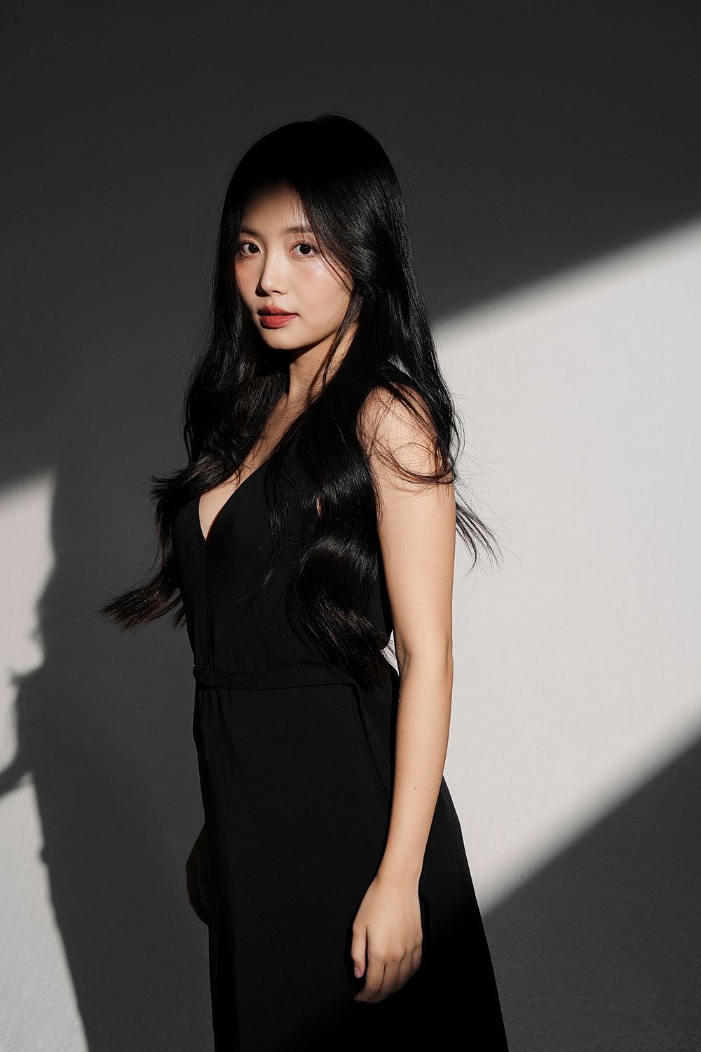 Woman in black dress with dramatic lighting