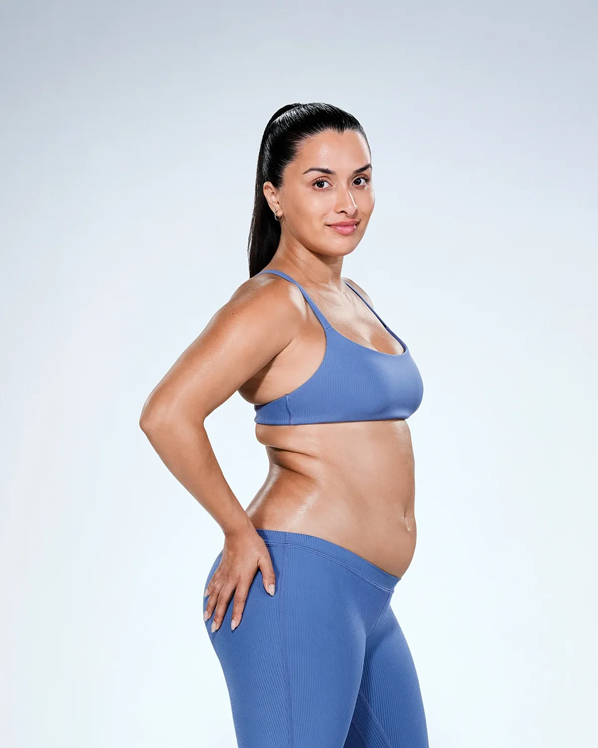Woman in athletic wear posing confidently.