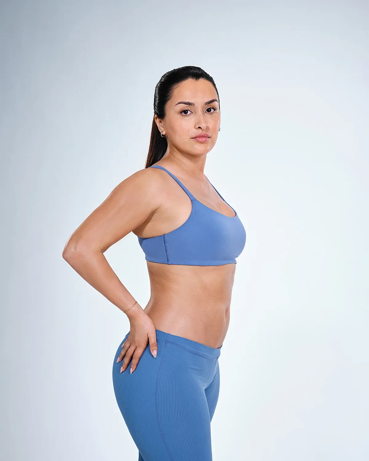 Athletic woman in blue activewear, profile view.
