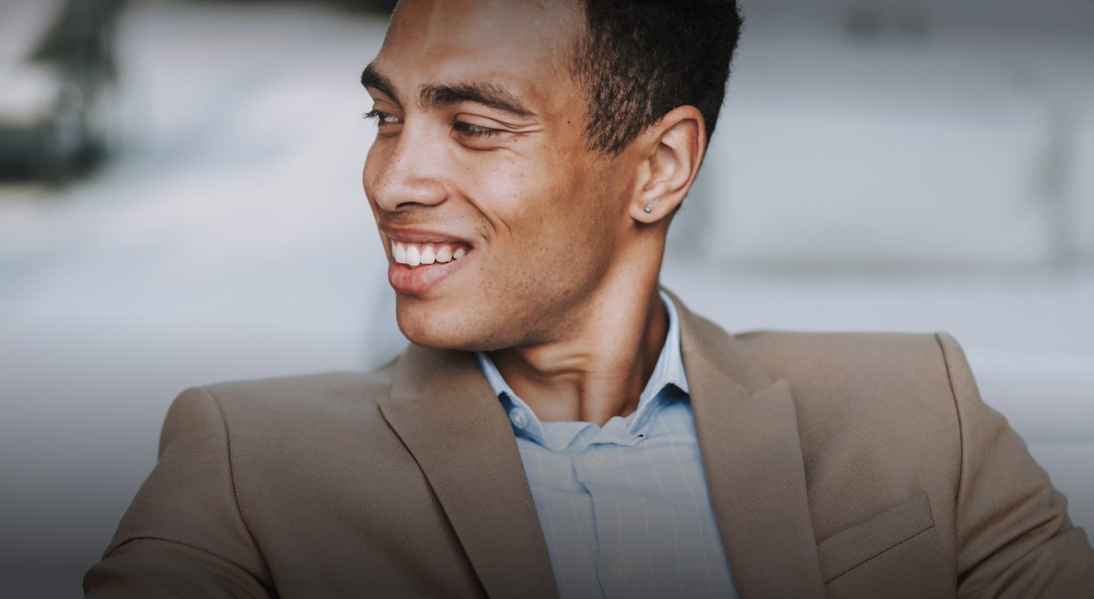 Smiling man in a suit, relaxed expression.