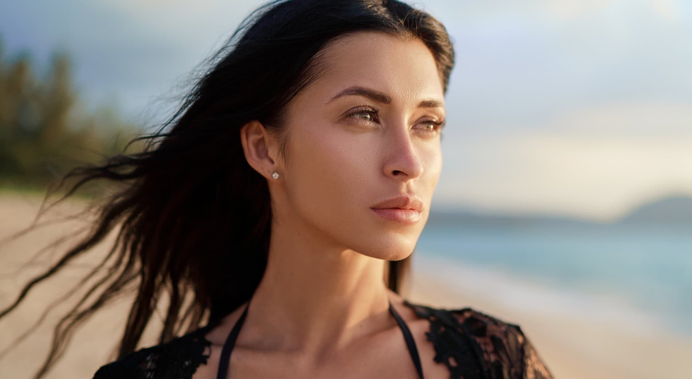 Woman with flowing hair at the beach.