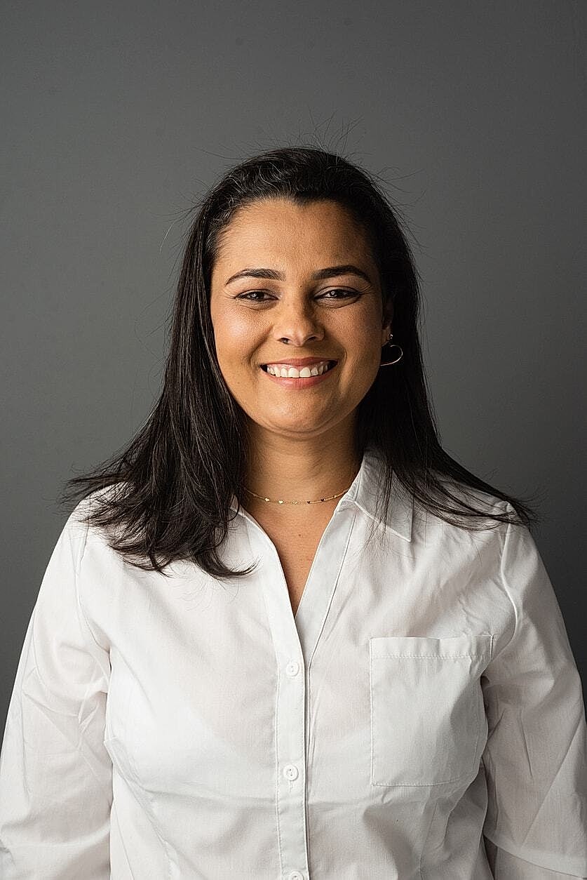 Smiling woman in a white shirt portrait.